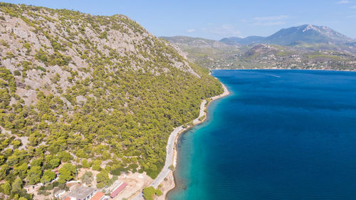 High angle view of sea and mountains against sky