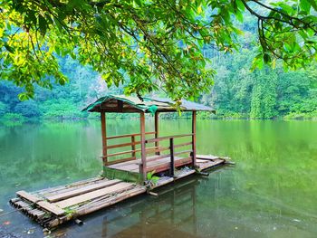 Gazebo by lake against trees