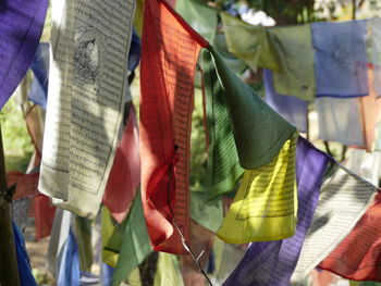 Close-up of multi colored prayer flags hanging outdoors