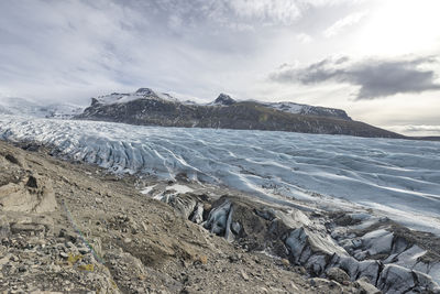 Scenic view of mountains and glacier against sky