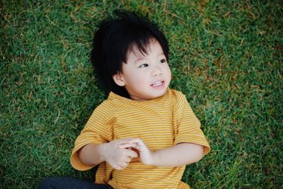 Portrait of girl sitting on grassy field