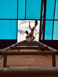 Low angle view of woman sitting on steps