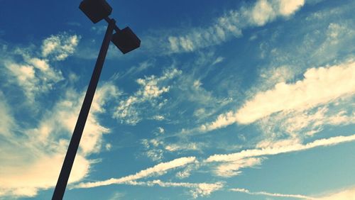 Low angle view of street light against blue sky