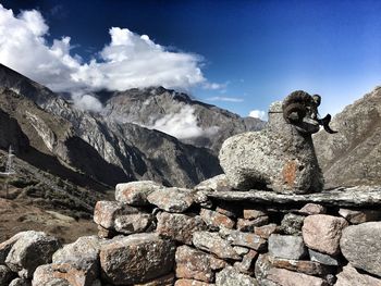 Statue on mountain against sky