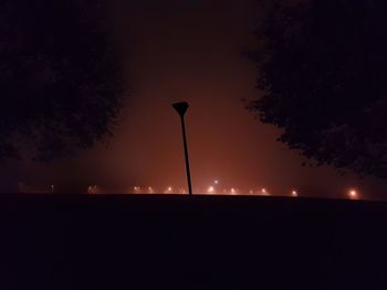 Low angle view of illuminated street light against sky at night