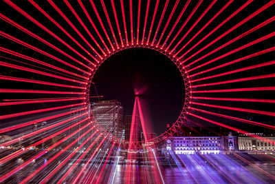 Illuminated ferris wheel at night