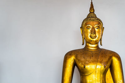 Statue of buddha against white background