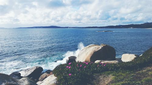 Scenic view of sea against cloudy sky