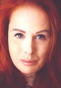 Close-up portrait of woman with redhead and gray eyes