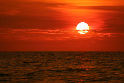 Scenic view of sea against orange sky