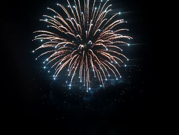 Low angle view of firework display at night