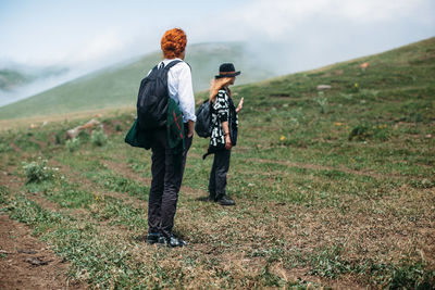 Rear view of two women on field