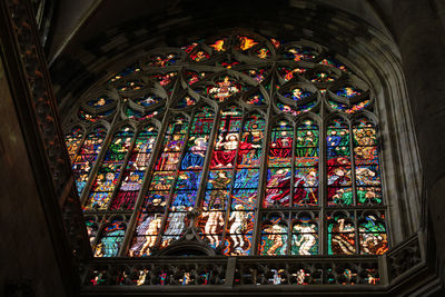 Low angle view of multi colored glass window in building