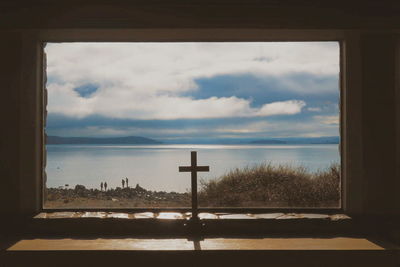 Scenic view of sea against sky seen through window