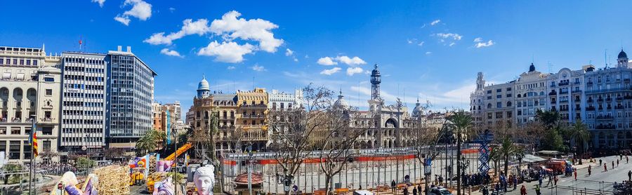 Panoramic view of people on street against buildings in city