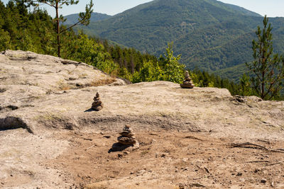Stone pyramids in a triangle formation, left by tourists at belintash sacred location.