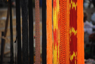 Close-up of multi colored thread hanging at market stall