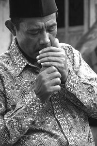 Close-up of man smoking cigarette while standing outdoors