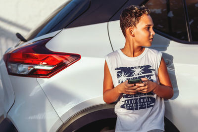 Portrait of little boy in car