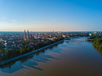 High angle view of river amidst buildings in city against sky