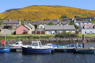 Houses by sea against sky