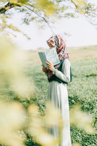 Woman holding umbrella standing outdoors