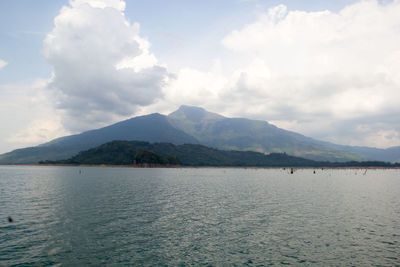 Scenic view of lake against cloudy sky