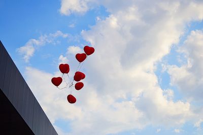 Low angle view of balloons against sky