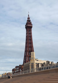 Tower of building against cloudy sky