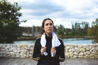 Woman with towel looking away outdoors