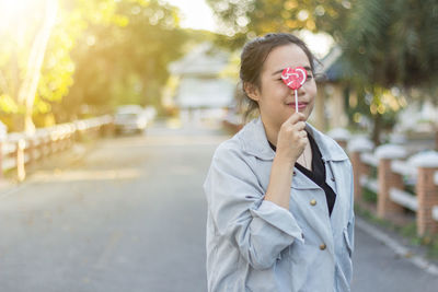 Portrait of young woman with lollipop