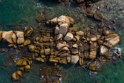 Aerial view of rocks in sea