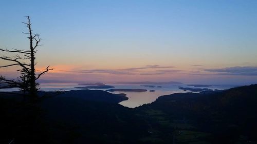 Scenic view of silhouette mountains against sky at sunset