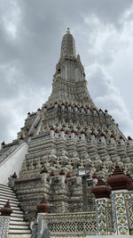 Pagoda low angle views at wat arun, under a dramatic cloudy sky