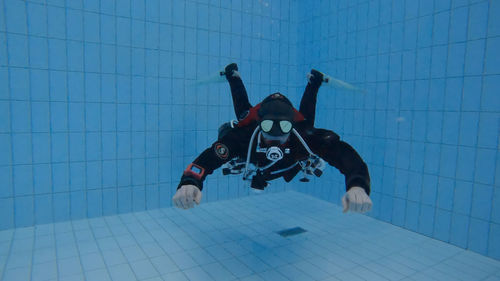 Scuba diver in the pool with sidemount tanks