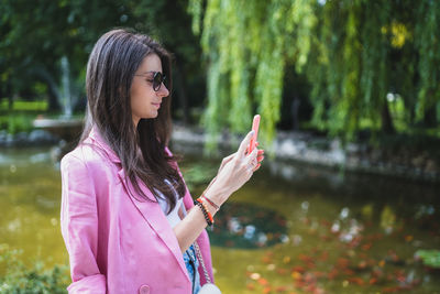 Midsection of woman standing on mobile phone