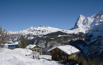 Snowcapped mountains against clear blue sky in murren switzerland
