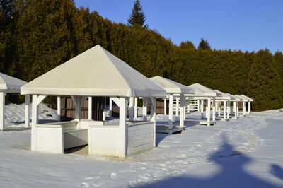 Built structure on snowcapped mountain against sky