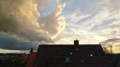 Low angle view of building against cloudy sky