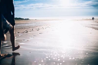 Man standing on beach against sky