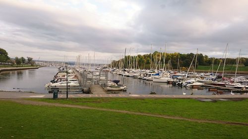 Boats moored in river against sky