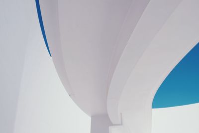 Low angle view of white ceiling against clear blue sky