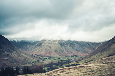 Scenic view of mountains against cloudy sky