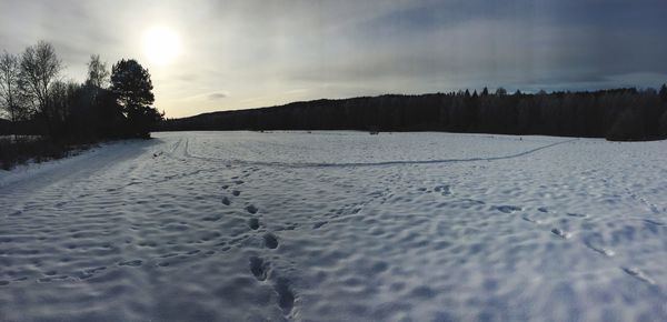 Scenic view of frozen landscape against sky