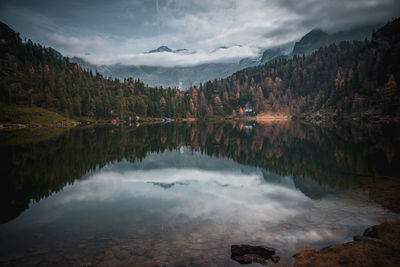 Cabin in the woods at mountain lake reedsee in the austrian alps in gastein in  moody fall colors
