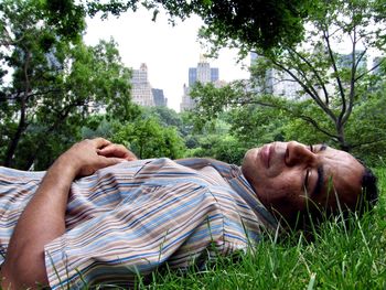 Man sleeping on grass in city