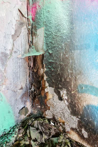 Close-up of water on rock against wall