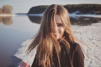 Portrait of smiling young woman in lake