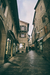 Street amidst buildings against sky in city