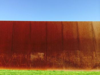 Built structure on grassy field against clear sky